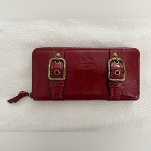 Authentic Coach patent leather double buckle red zip around wallet.